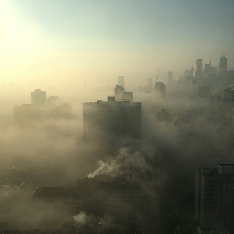 Delhi high-rise blocks dissolving into heavy smog
