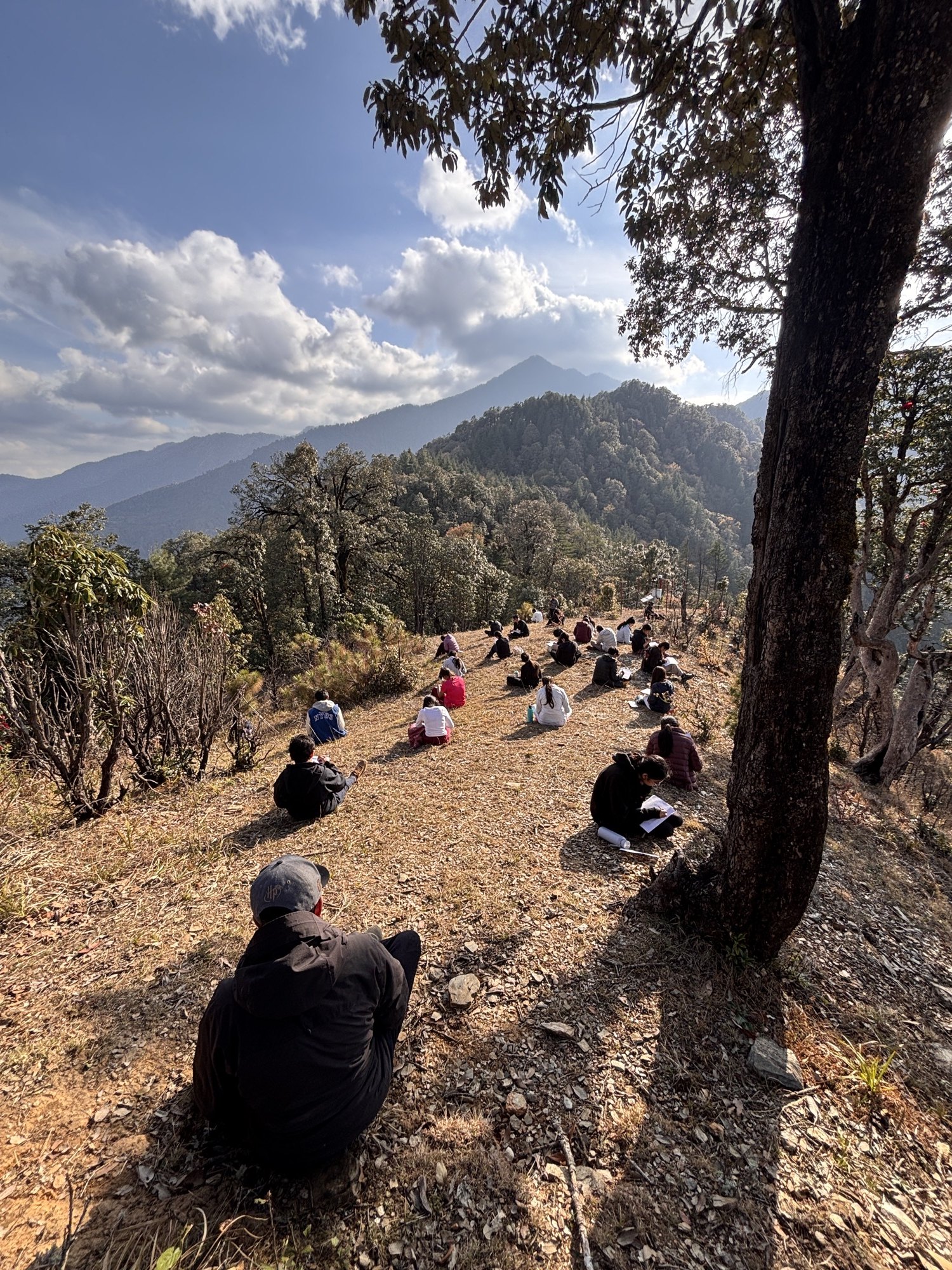 A large group seated on a hillside slope