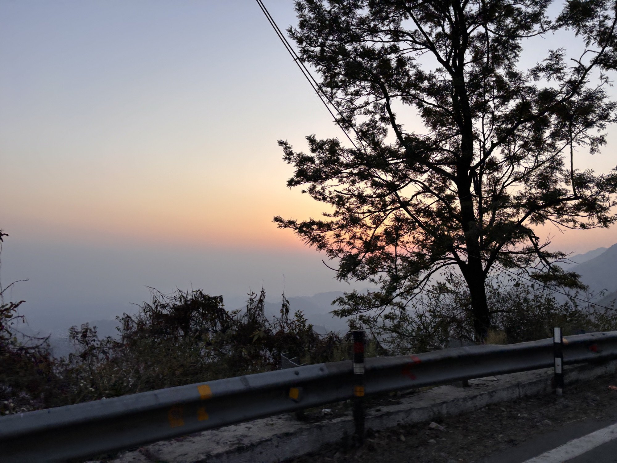 A ridge road curving away at dusk