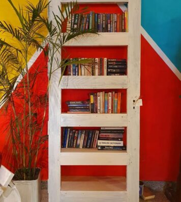 An old discarded door, converted into a bookshelf {{brizy_dc_image_alt imageSrc=